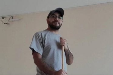 Argentine man cleaning a house as part of his job, representing hard work and breaking social stereotypes