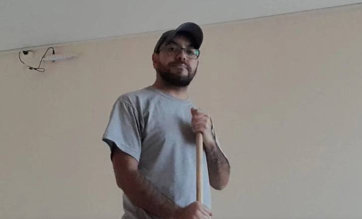 Argentine man cleaning a house as part of his job, representing hard work and breaking social stereotypes